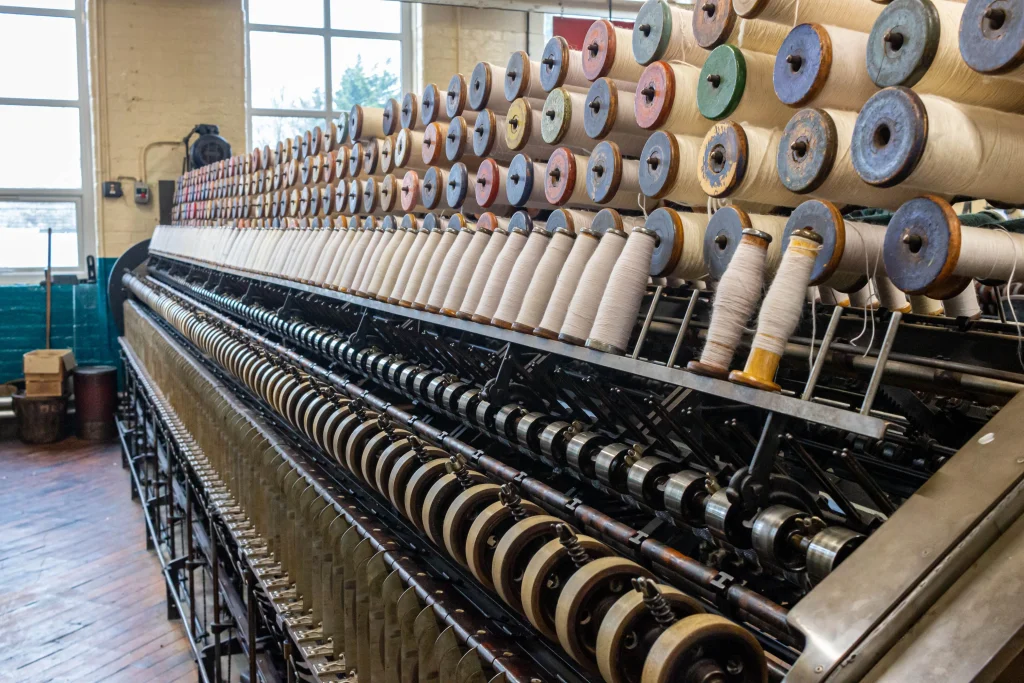 Industrial circular knitting machine in a Bangladesh garment factory producing high-quality knit fabrics.